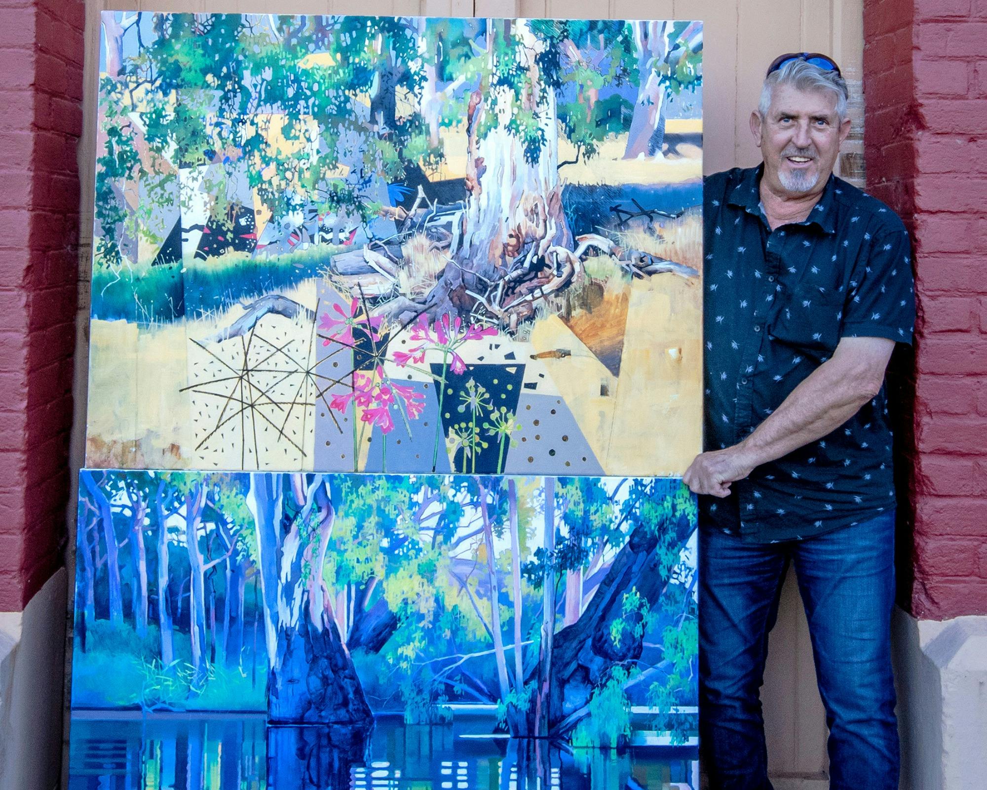 Male artist holding his oil on canvas artworks