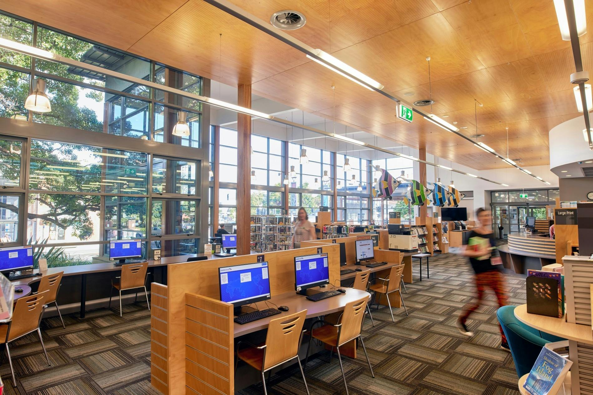 Thirroul Library interiors with computer workstations and large windows.