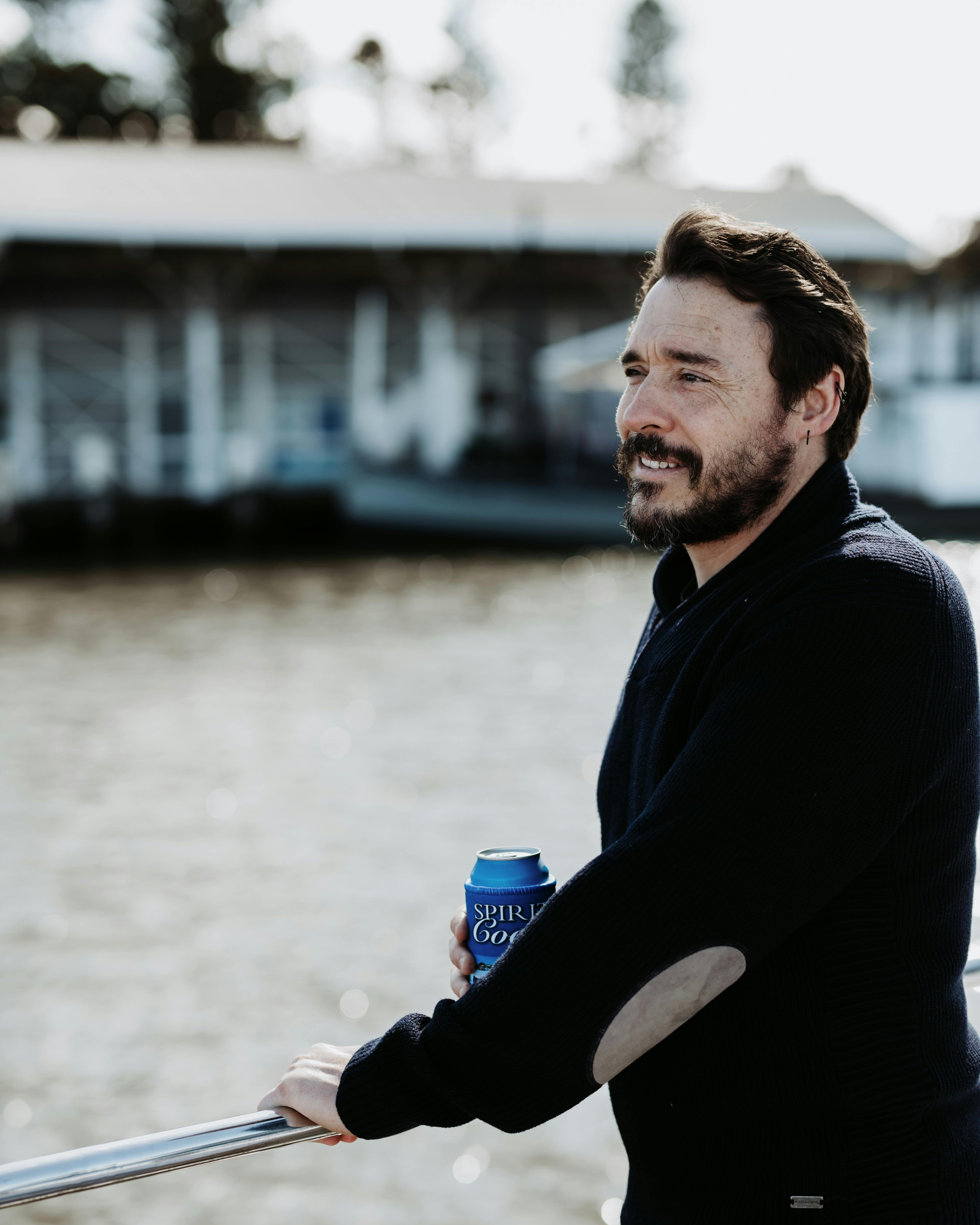 Man enjoying drink on stern of the vessel