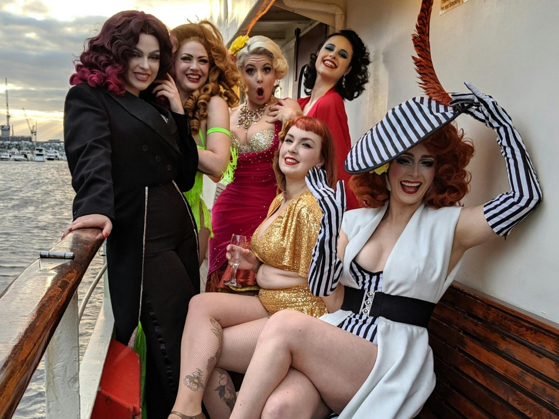 Six performers posing on the Lady Cutler Melbourne Showboat at sunset.