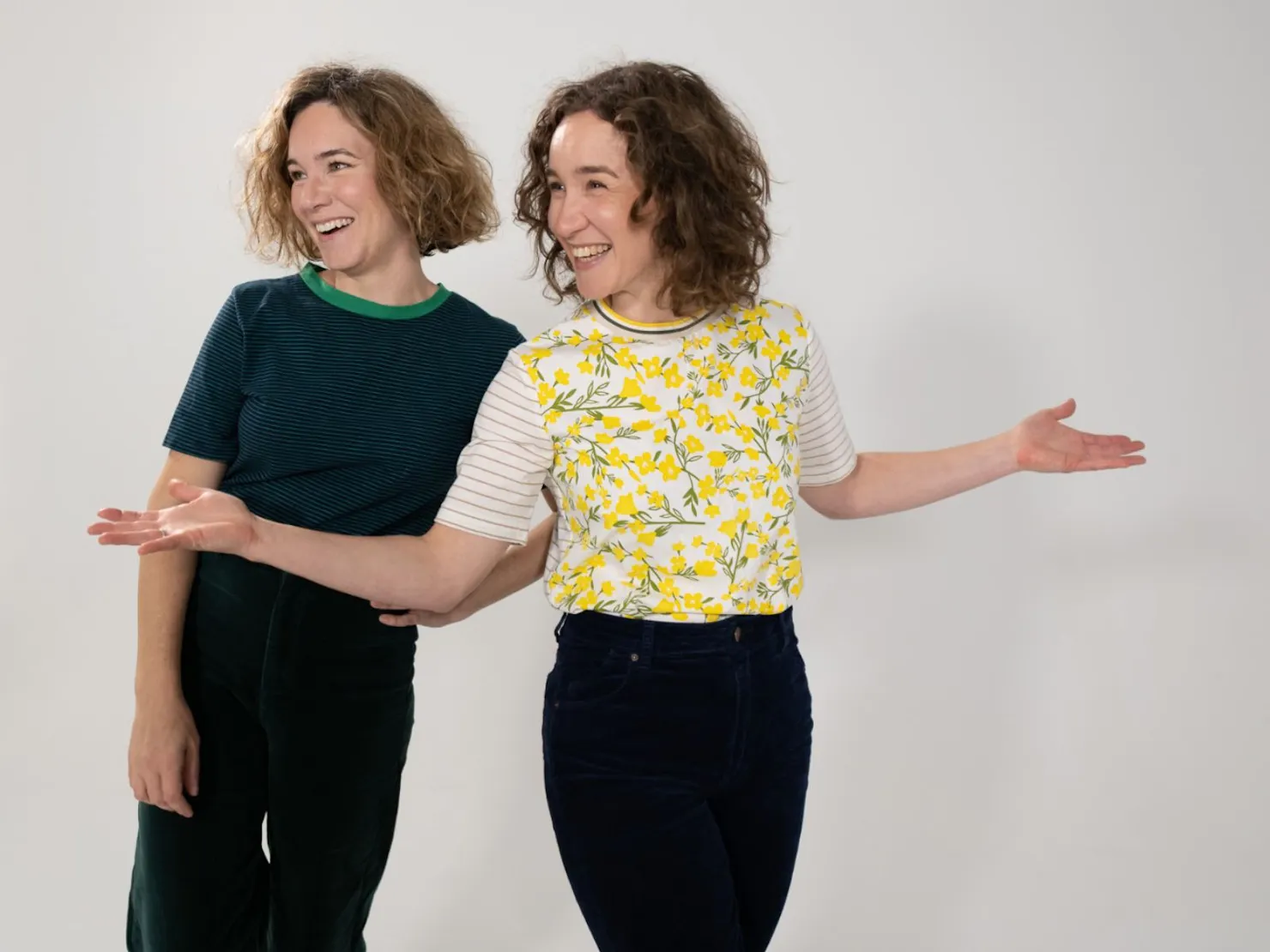 2 ladies one in black shirt and trousers and the other with a yellow shirt and black trousers