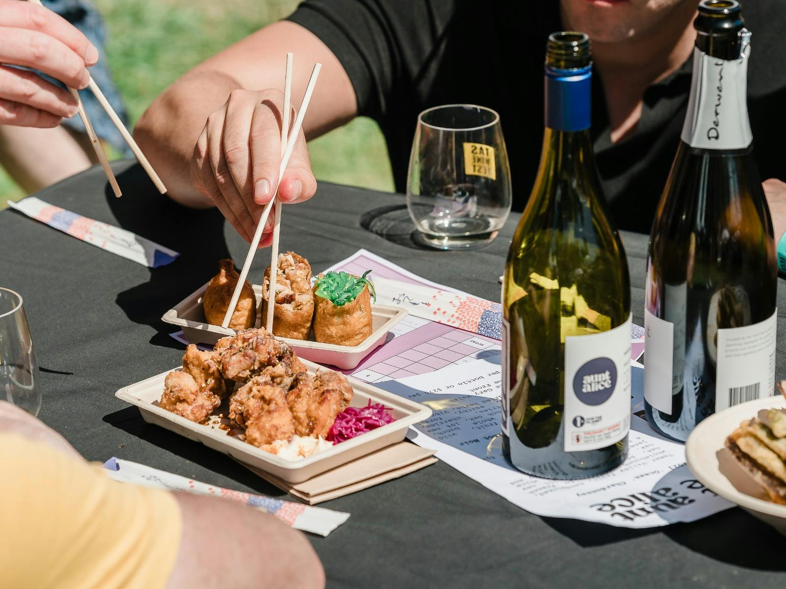 Image of people eating food at a table at the Tasmanian Wine Festival