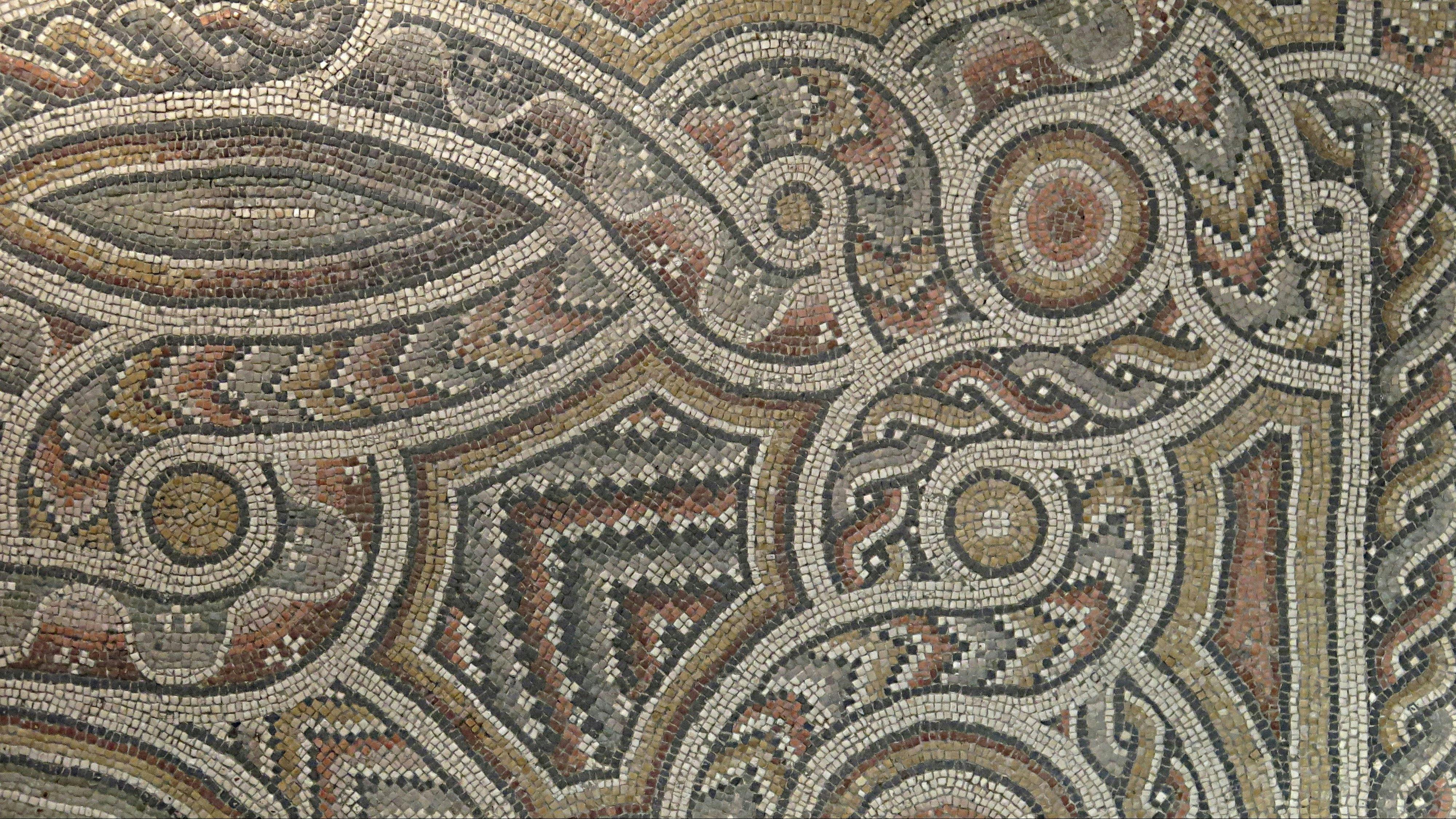 mosaic floor panel of polychrome stone tesserae creating a geometric and guilloche pattern