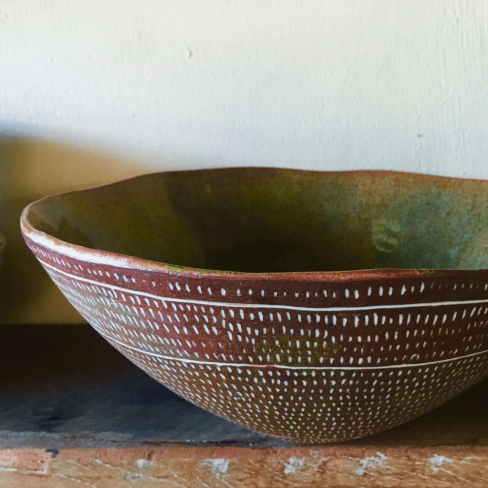 Large brown ceramic bowl with white dots.