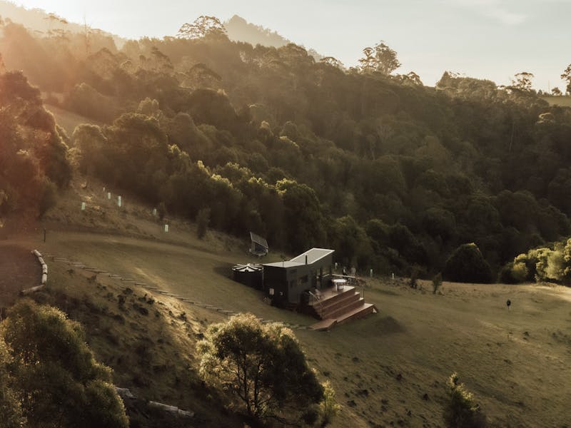 An aerial drone shot showing the tiny home at sunset.