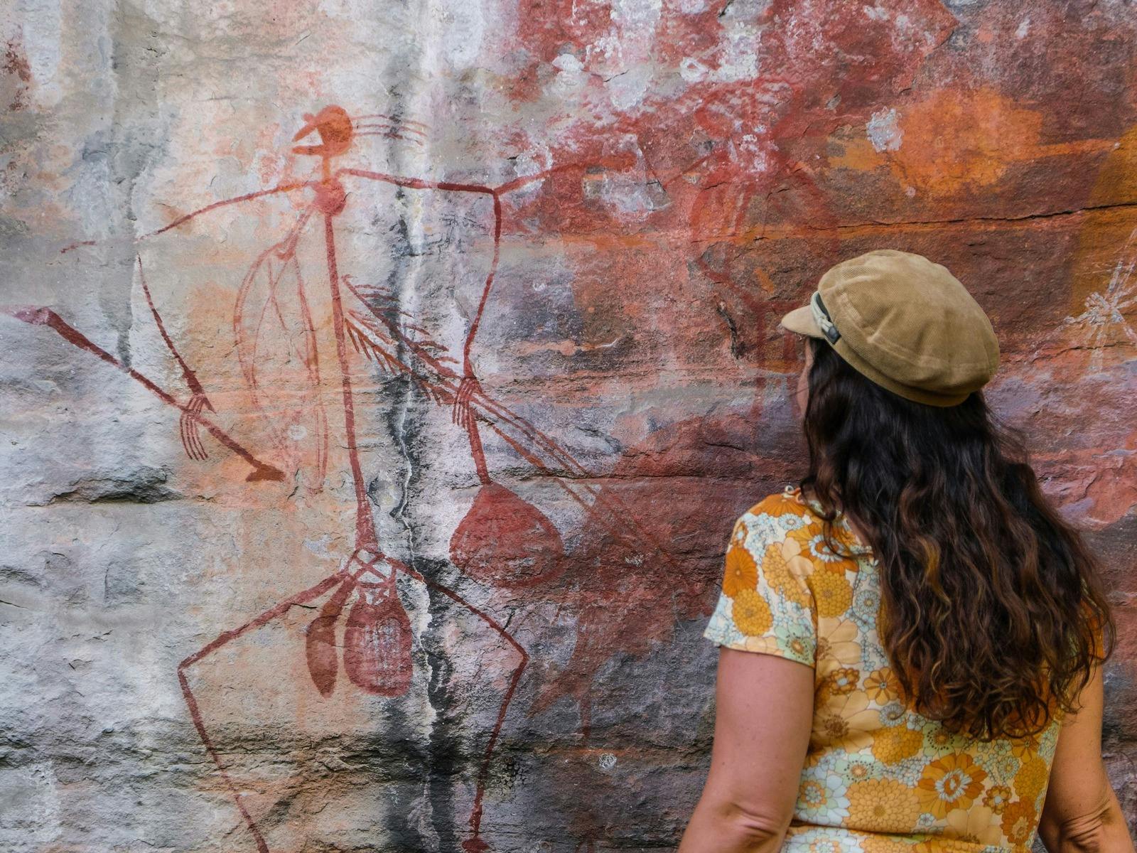 Lady looking at rock art at Ubirr