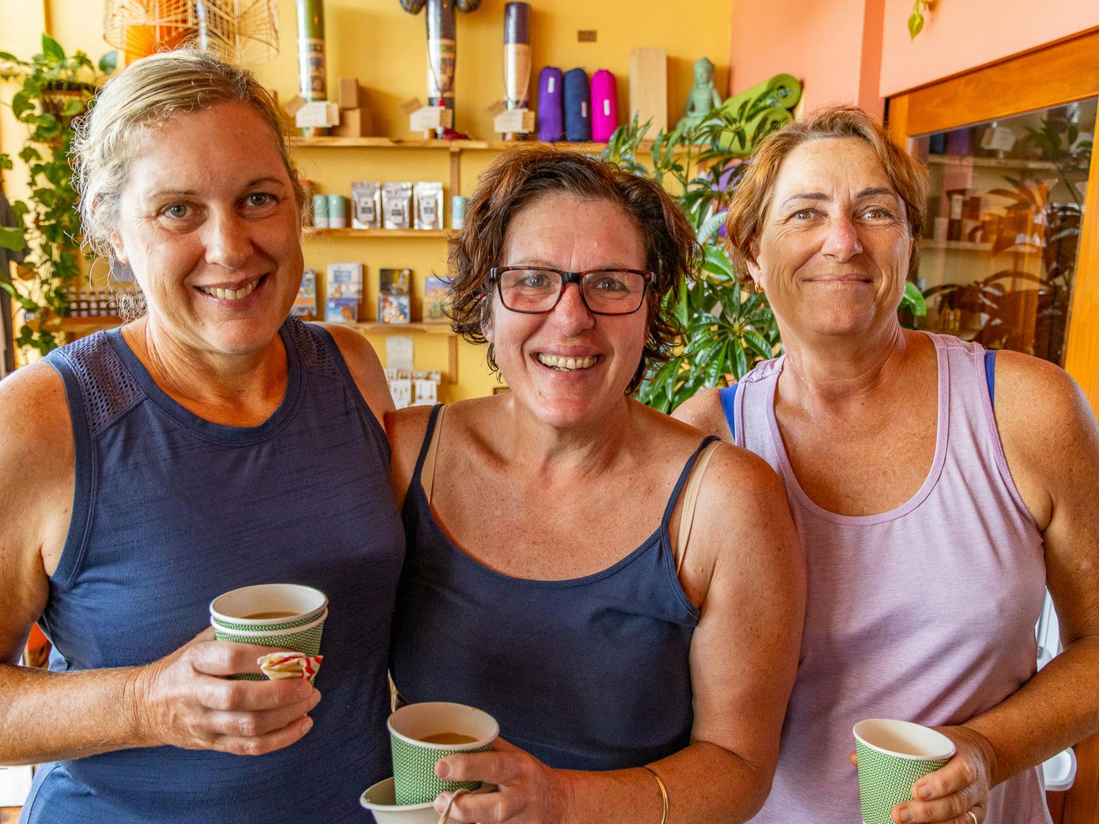 3 women smiling while drinking chai together