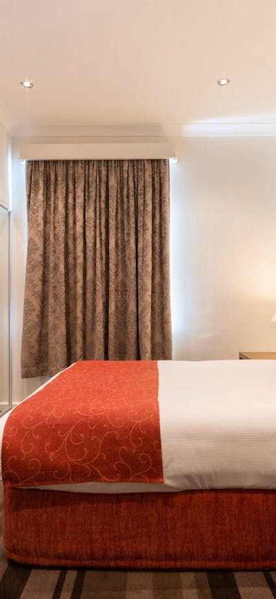 Hotel Room with Queen Bed, Armchairs and TV