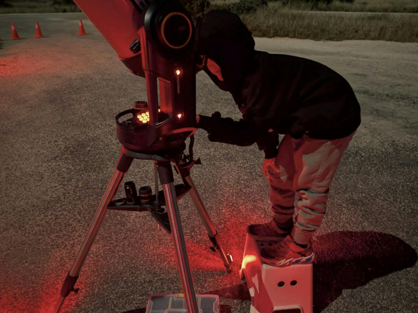 Young guest looking through a telescope during a Ningaloo Stars astronomy session