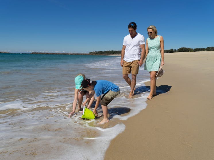 Family walking on Blacksmiths Beach