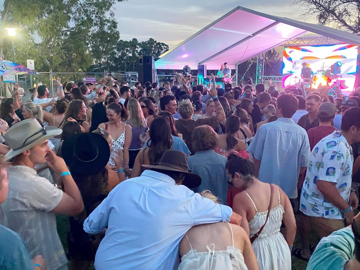 crowd dances to outdoor DJ