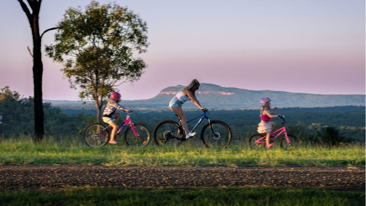 family enjoying sunset on bicycles