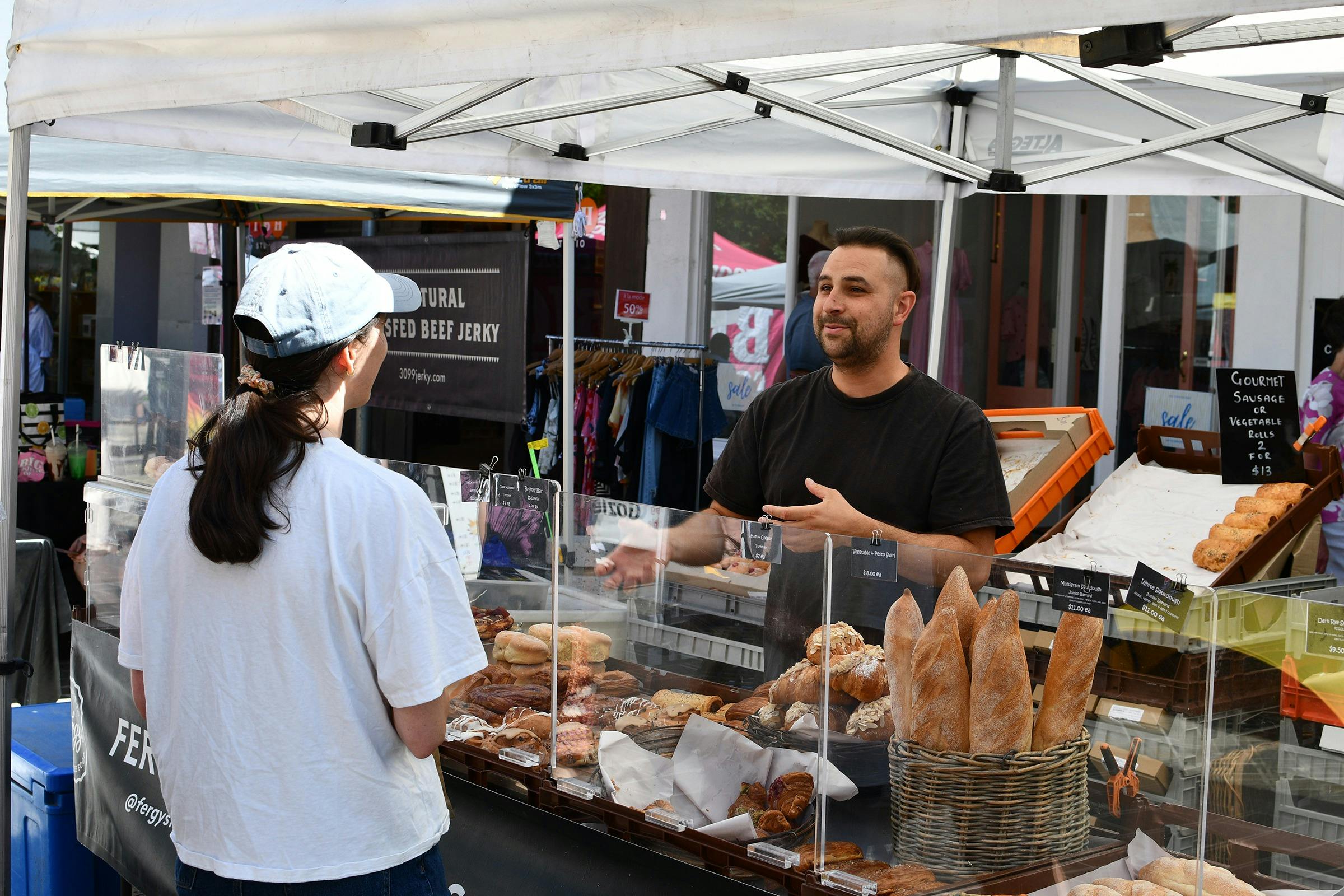 An enthusiatic stallholder talking to a customer