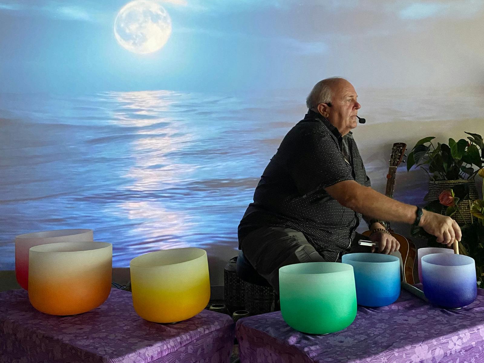 Man playing crystal singing bowls