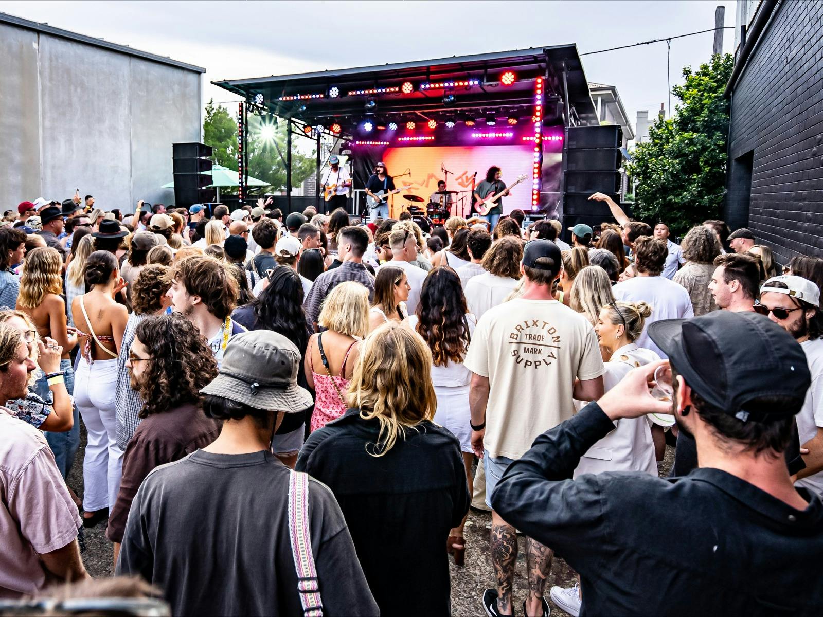 A crowd gathers in front of the stage in the Earp Distillery car park during Carrodise 2023