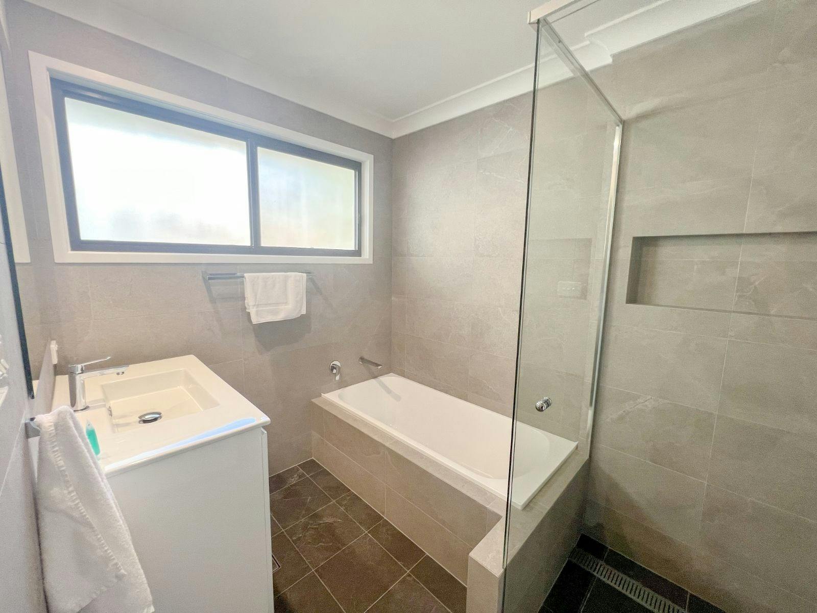 The main bathroom features a spacious bath and shower