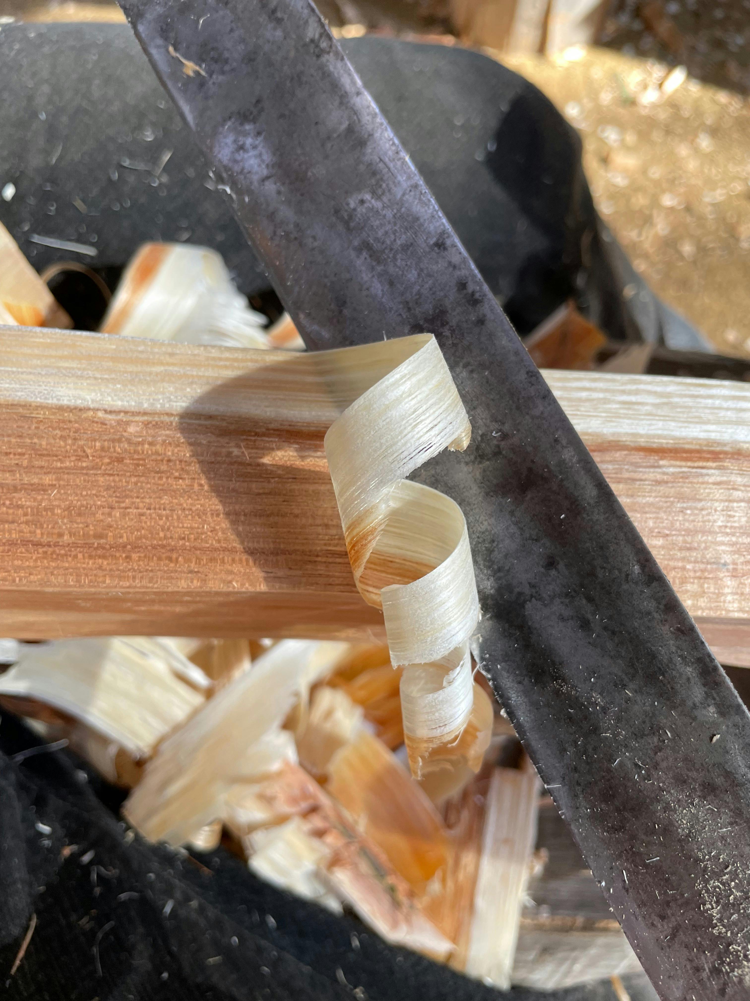 Shavings of Silver Wattle coming off a draw knife at Wisdom Through Wood
