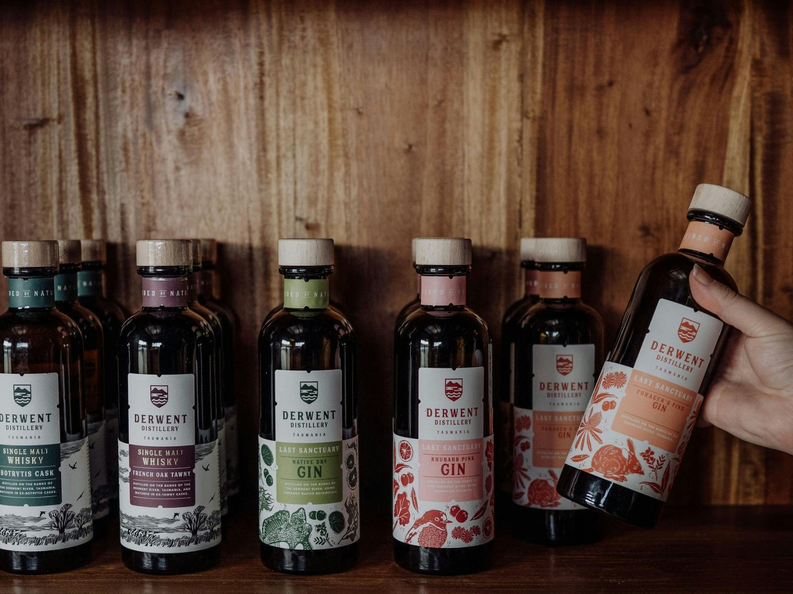 Gin, whisky and liqueur bottles on a shelf in the distillery cellar door