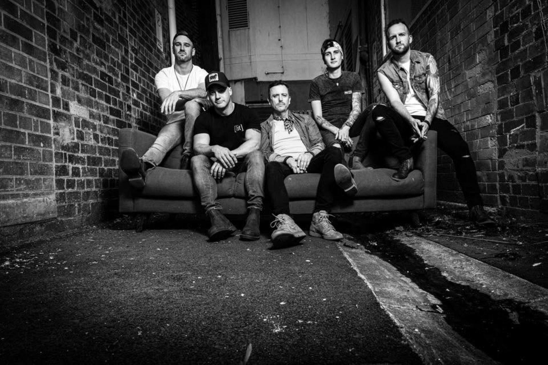 Australian country rock band Hurricane Fall poses together in a black-and-white promotional photo, s