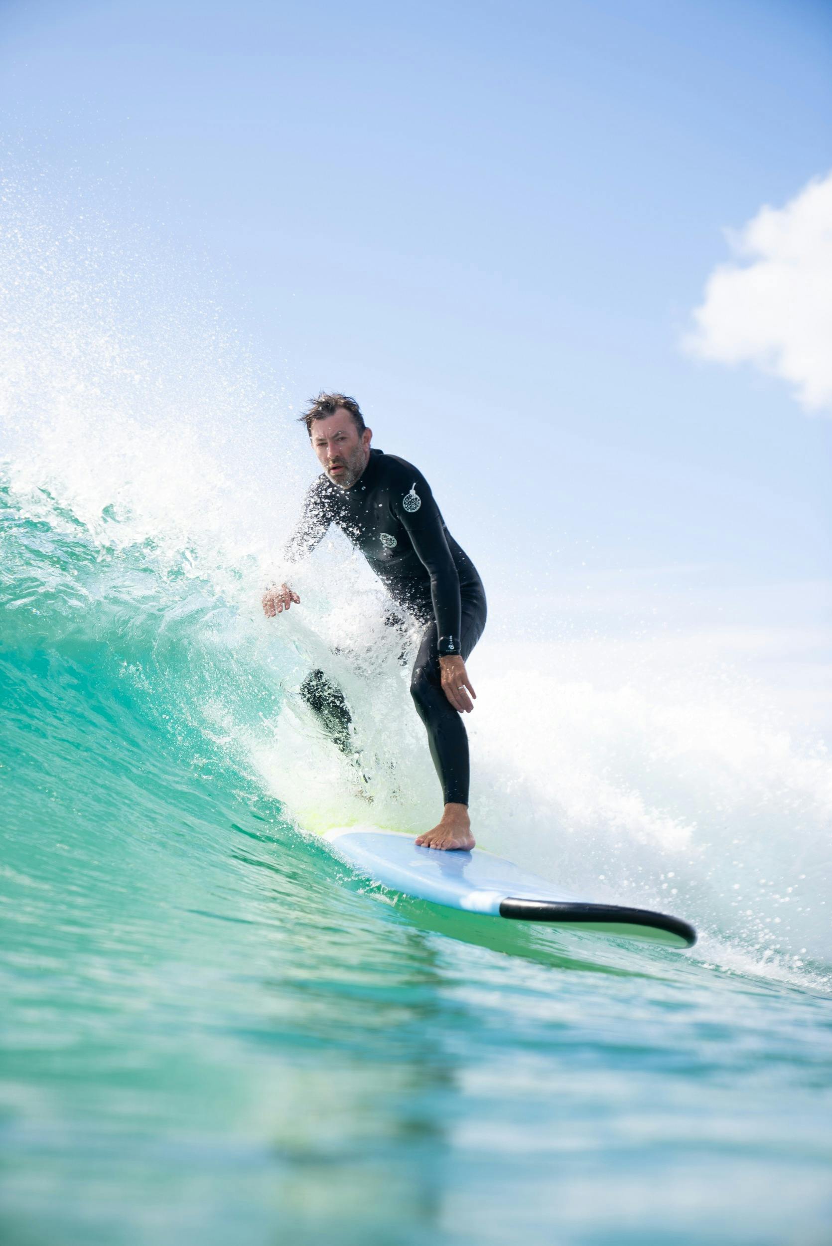 Man riding surfboard at Manly Beach