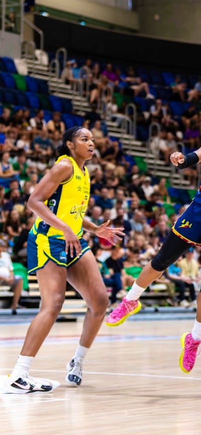 UC Capitals player shooting the basketball while a defender closes in.