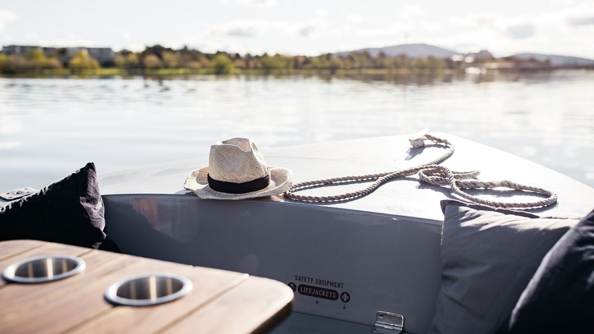 A GoBoat electric picnic boat sits on the water