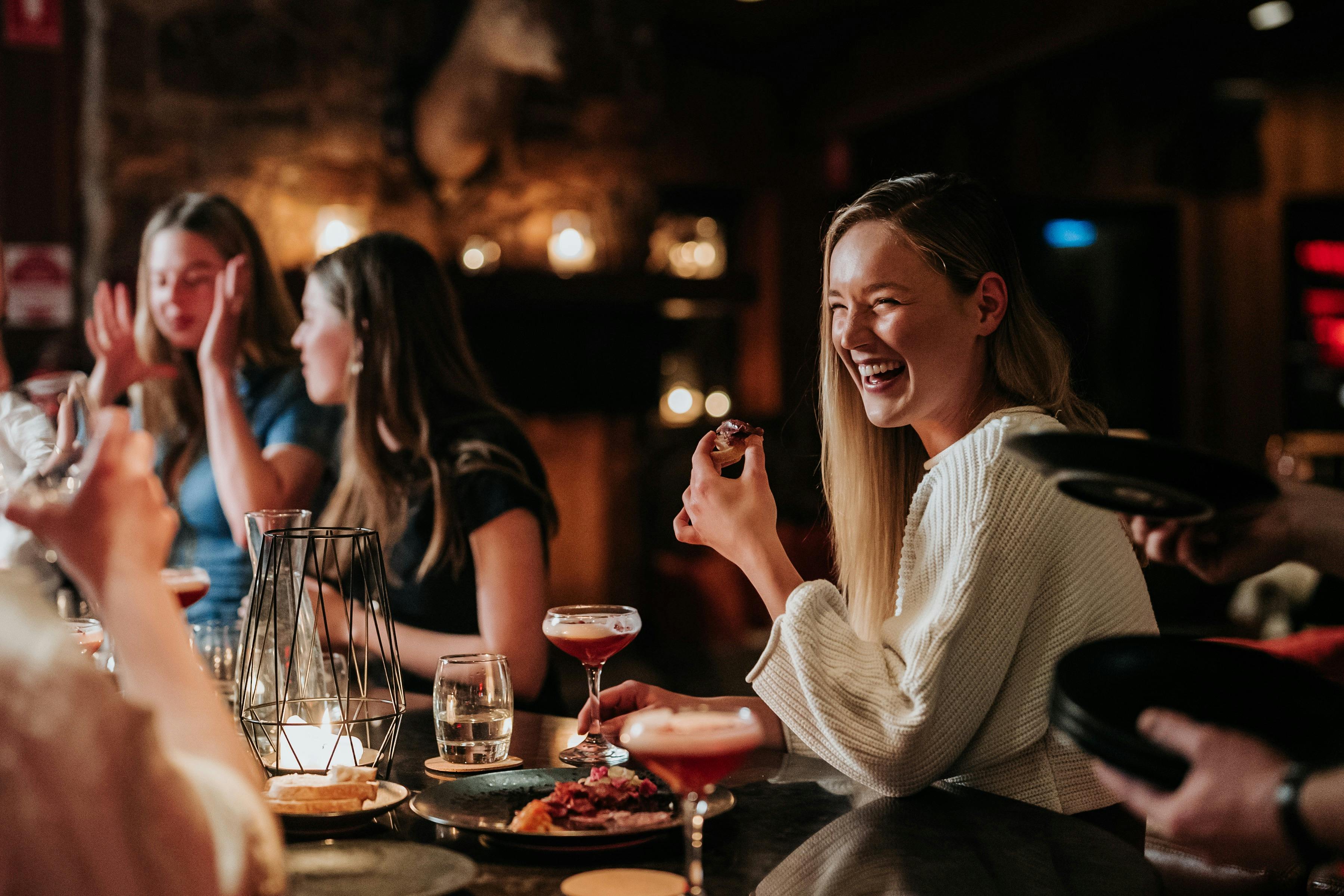 People enjoying drinks and food while out in the Falls Creek village