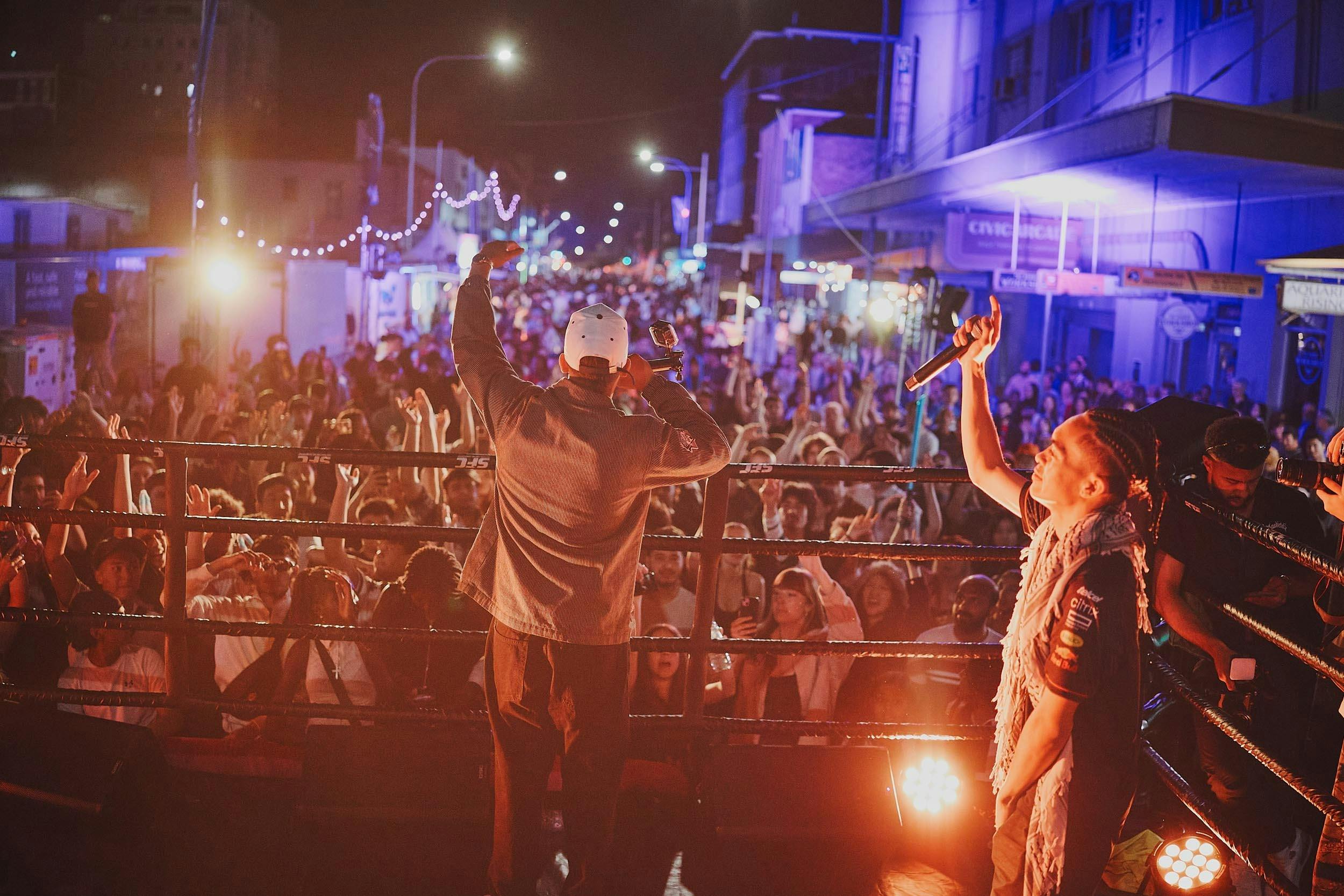 Man on stage performing to crowd
