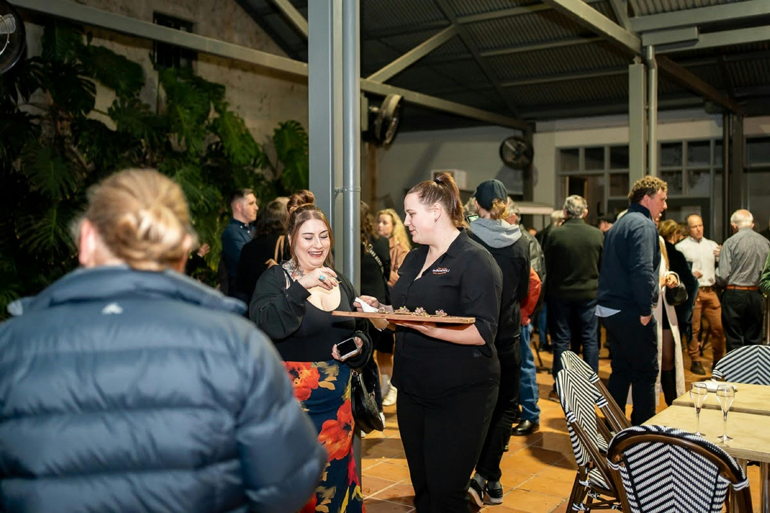 Canapes being served by staff outdoors - Legacy Dinner