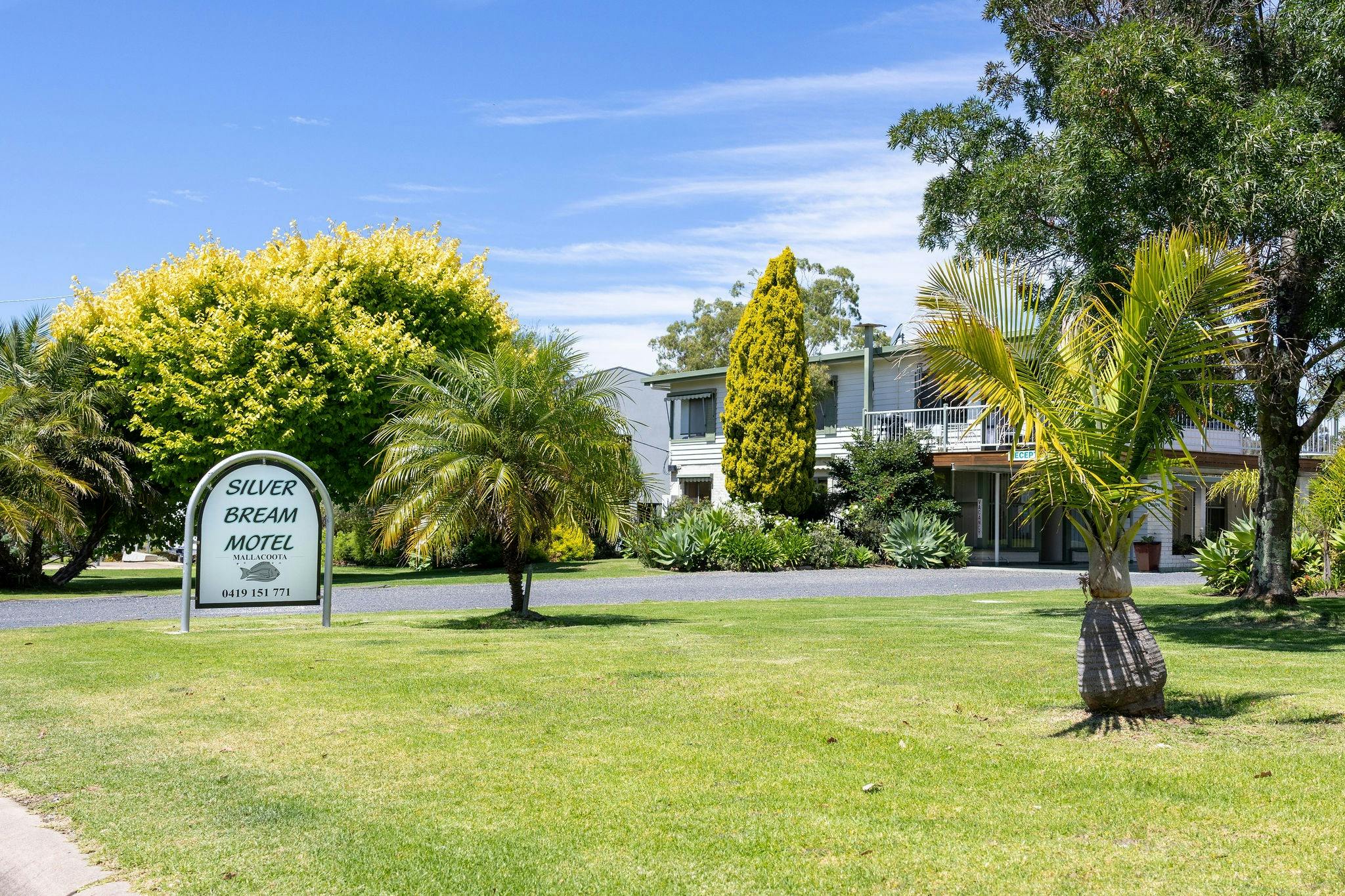 Silver Bream Motel Mallacoota grounds with property sign and gardens
