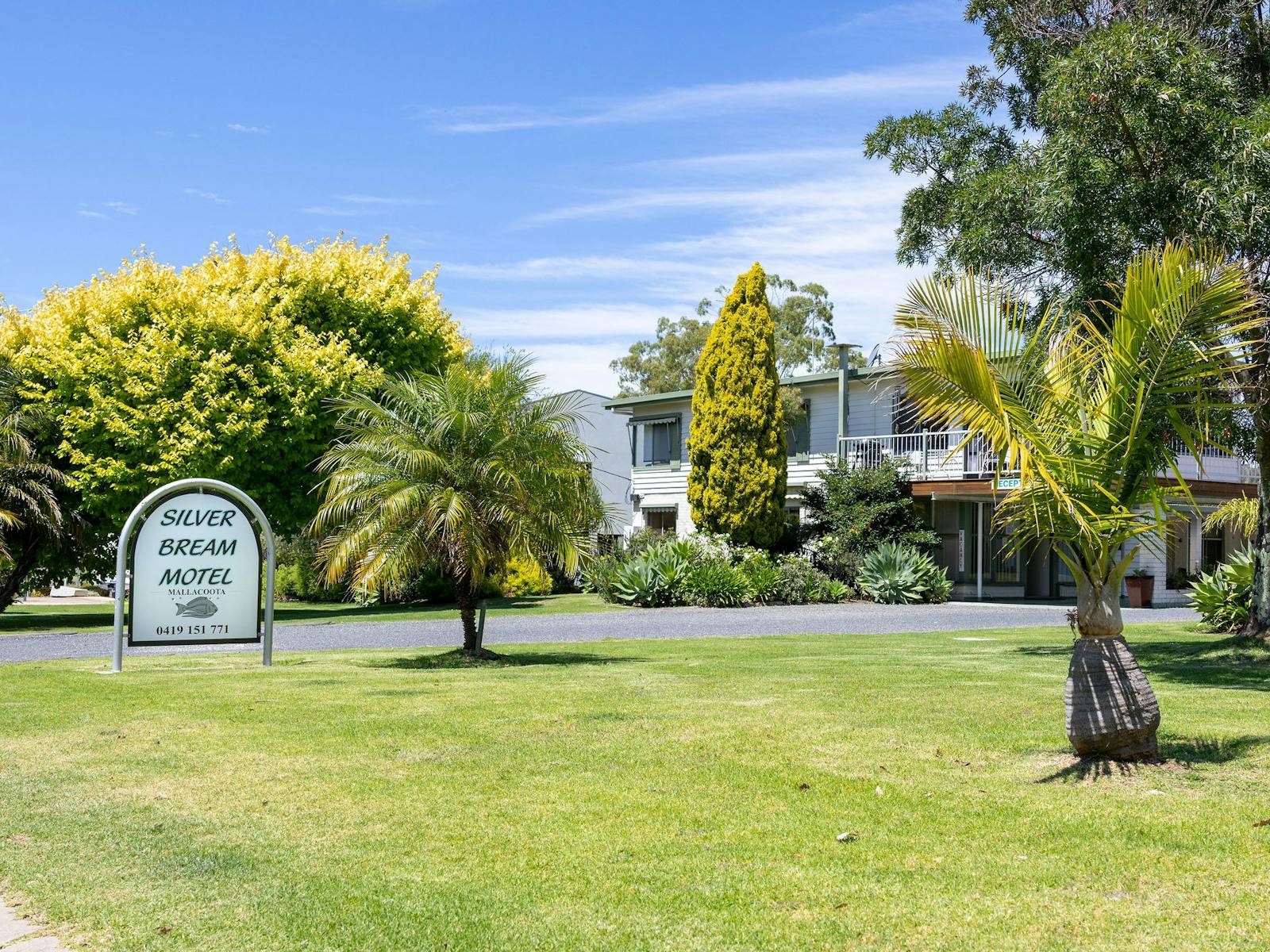 Silver Bream Motel Mallacoota grounds with property sign and gardens