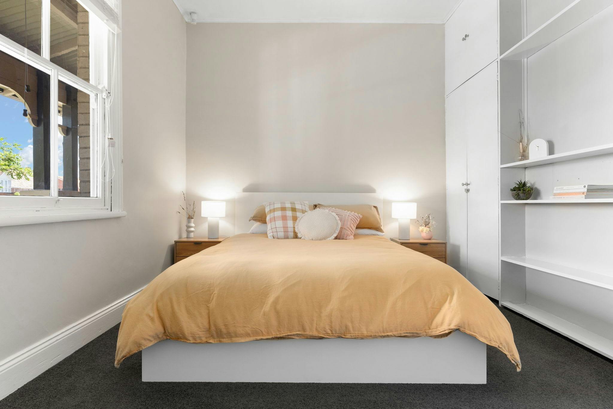 Queen bedroom with side tables and shelving