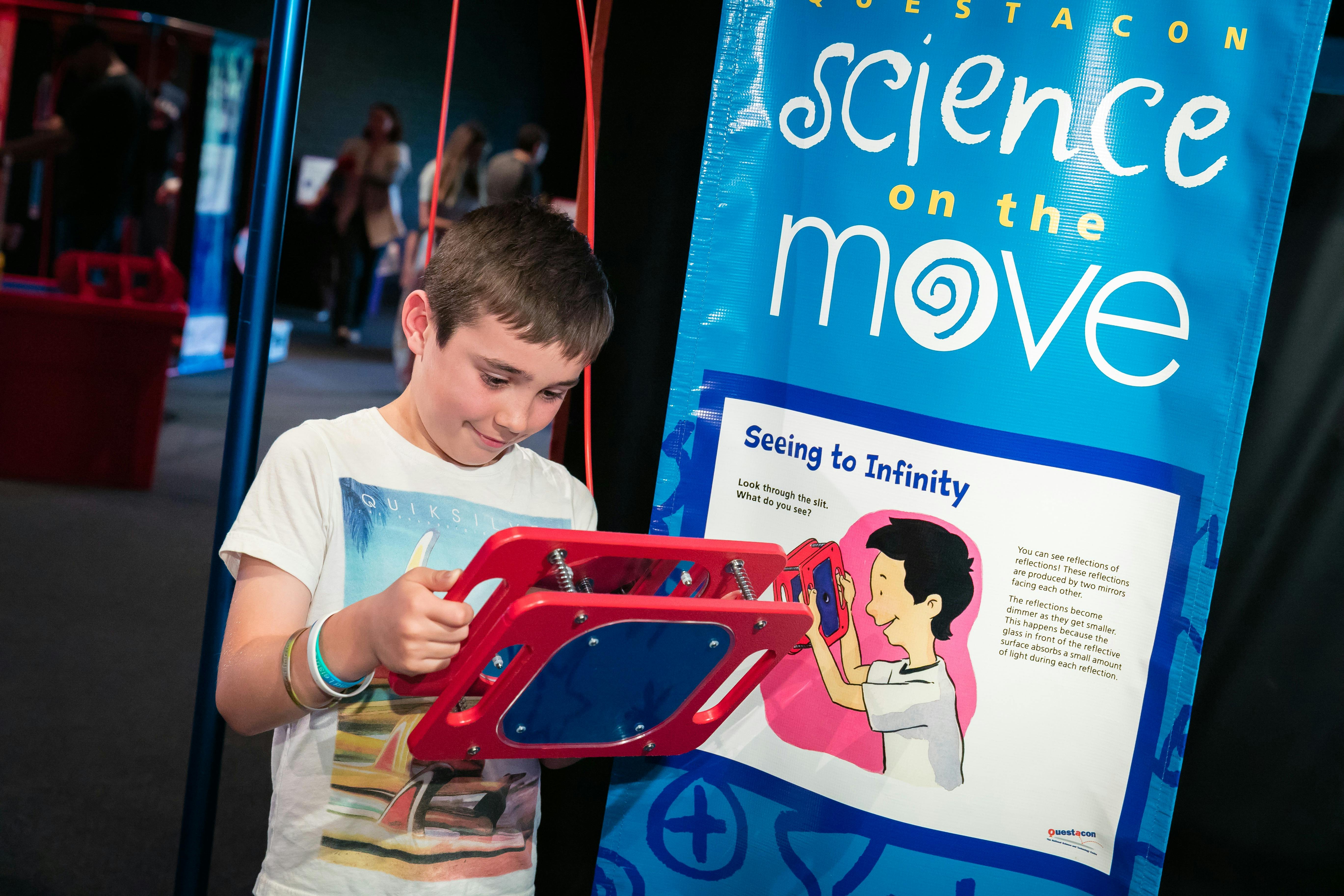 A child uses a display at the Science on the Move exhibition
