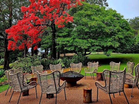 chairs by the fireplace outside within nature