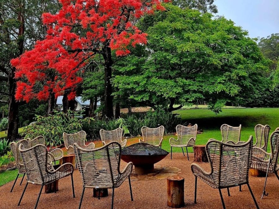 chairs by the fireplace outside within nature