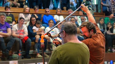Two artists working with molten glass