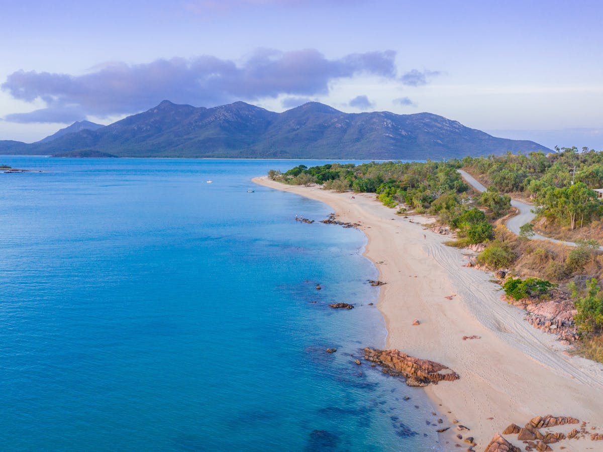 Aerial view from a picturesque mainland beach to the hilly Gloucester island