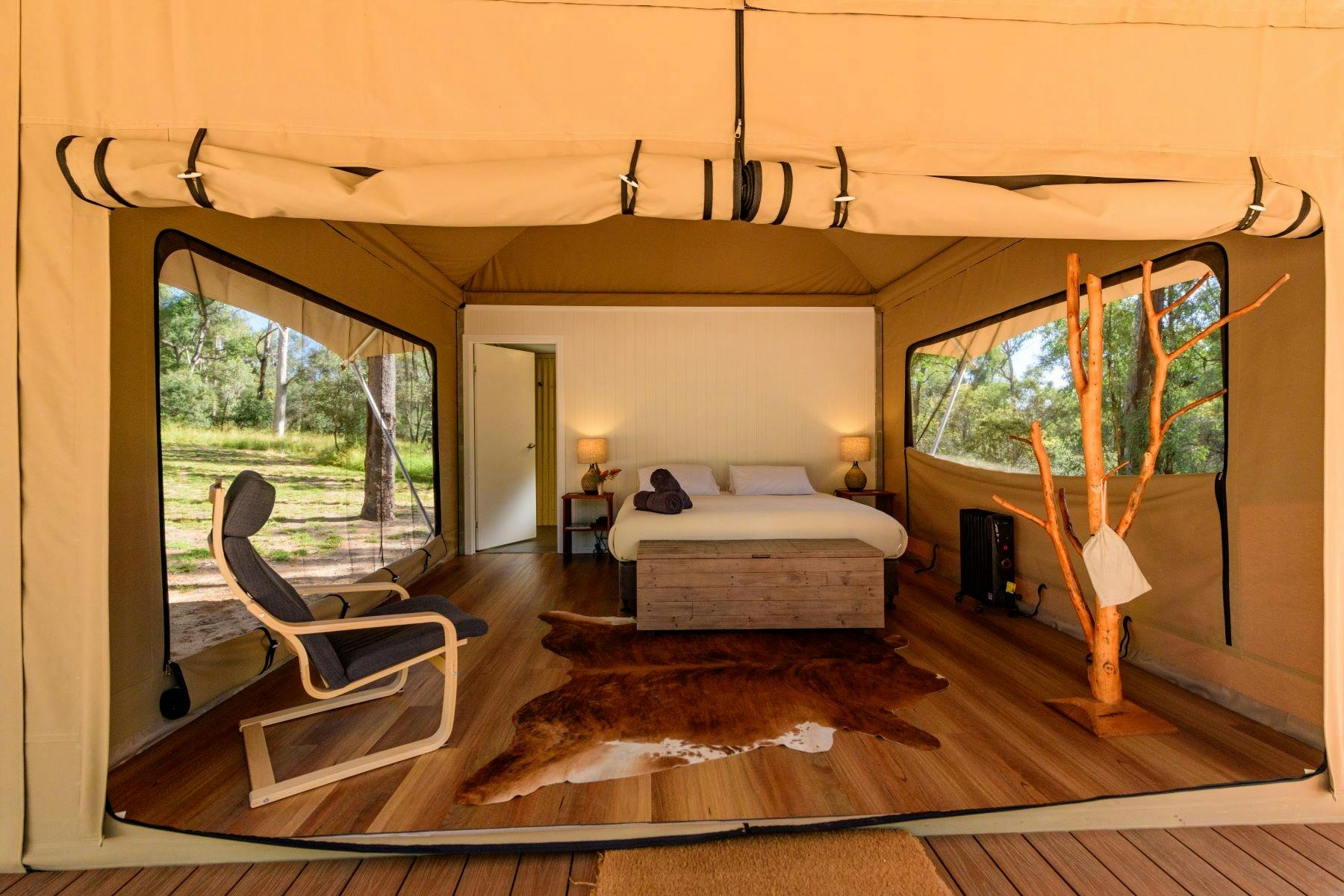 Wallaroo Retreat queen room wide view showing bed, chair, decorative tree and ensuite