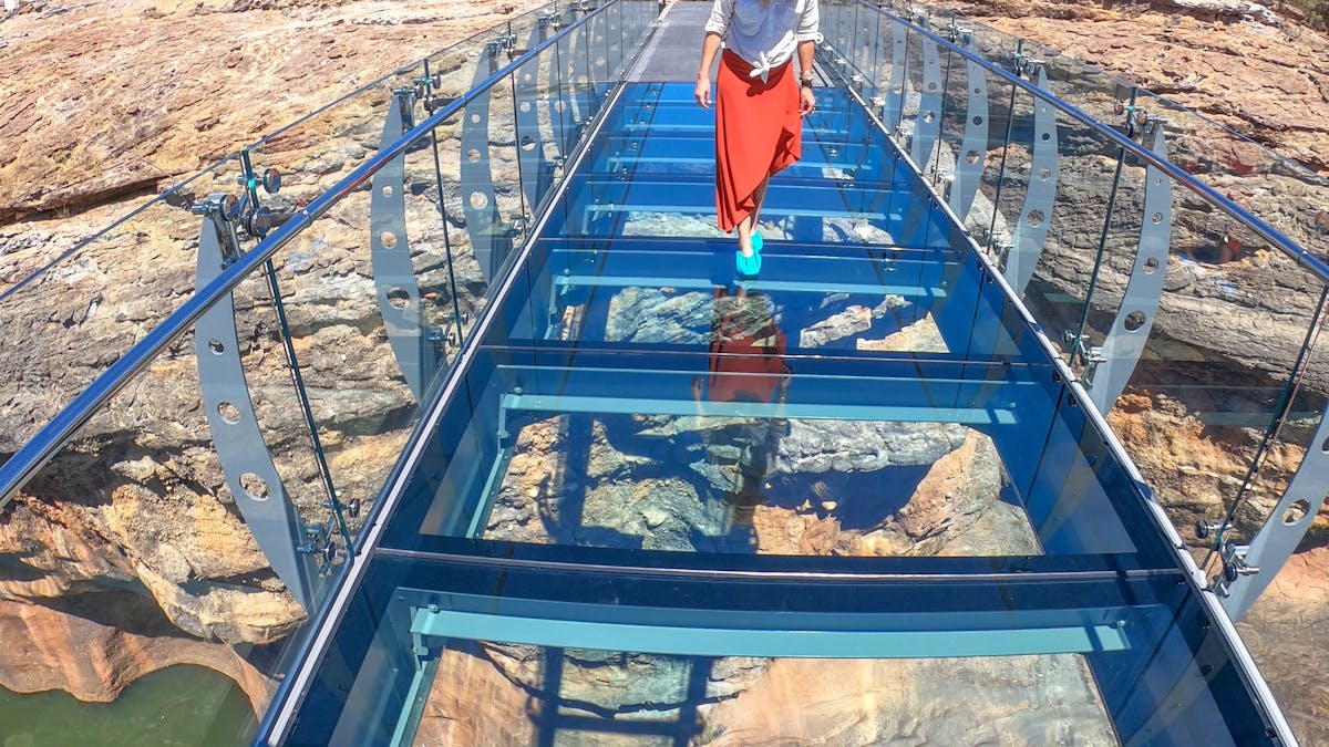 Walking across glass bridge