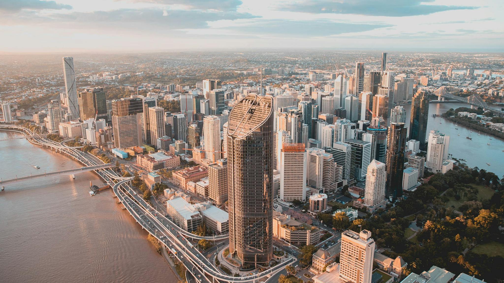 Aerial view of Brisbane CBD skyline at sunset, with the Brisbane River and Story Bridge. Aerial view of Brisbane CBD skyline at sunset, with the Brisbane River and Story Bridge.