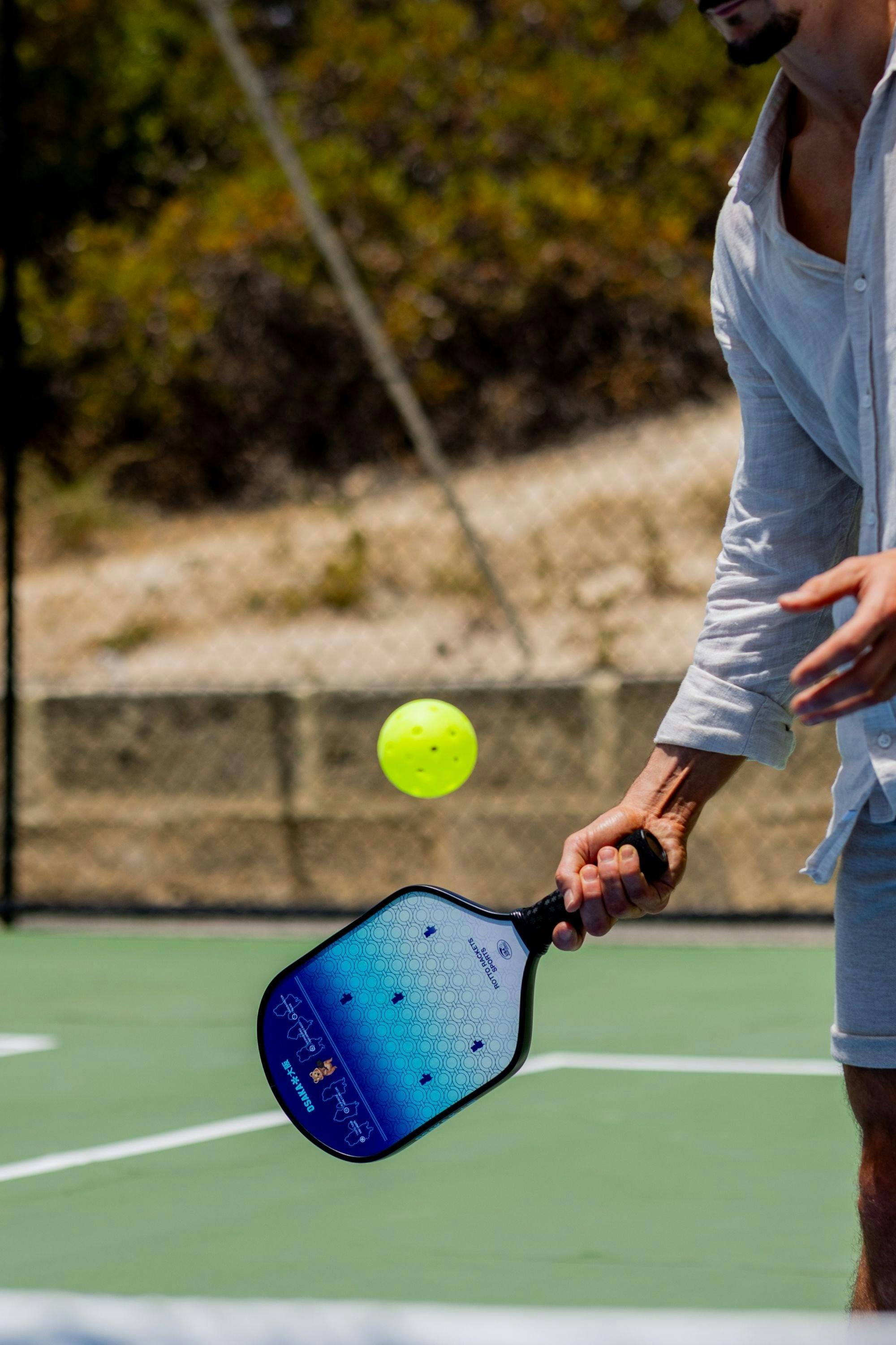 Close-up of a pickleball paddle and ball during play at Rotto Rackets Sports.
