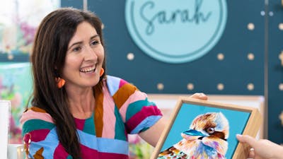 Art By Sarah showing a customer her artwork