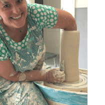 photo is of Zeynep making a tall vessel on the pottery wheel