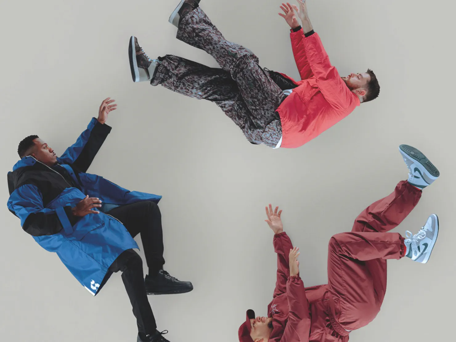 3 people laying in a circle posing for a photo