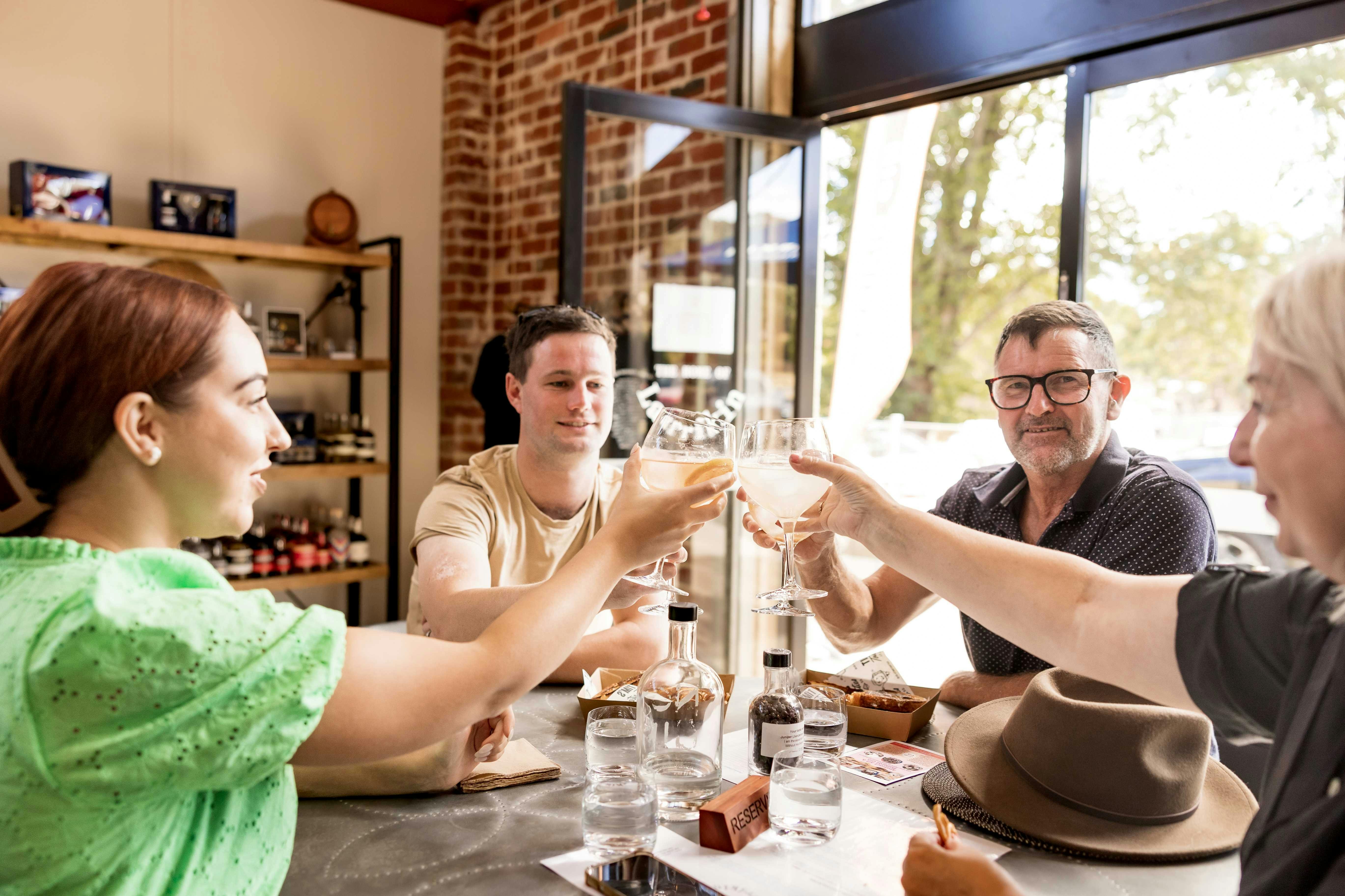 group of four raising their glasses for a toast