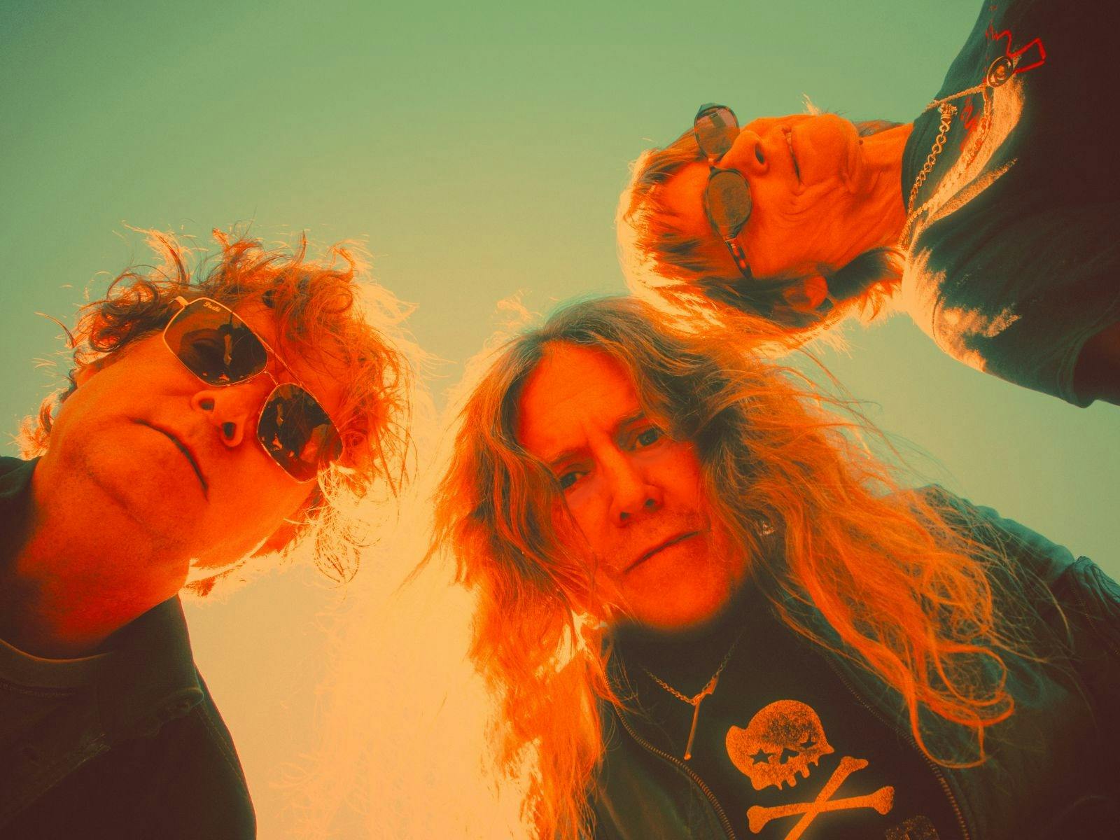 The three folks from Spiderbait staring down at you