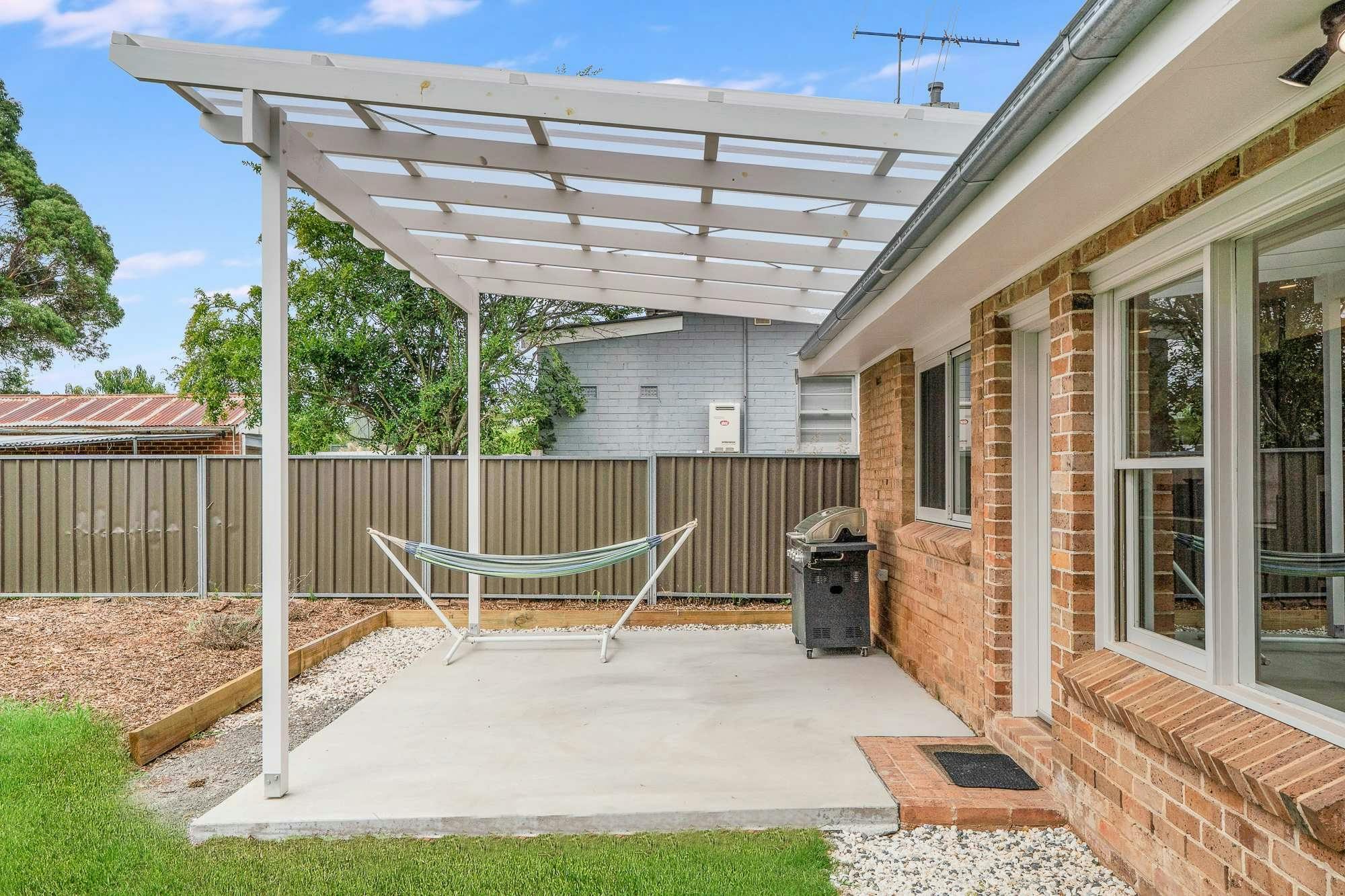 Undercover patio with hammock, bbq and concrete.