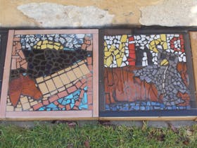 Pavers decorated with mosaics by art students from AAS