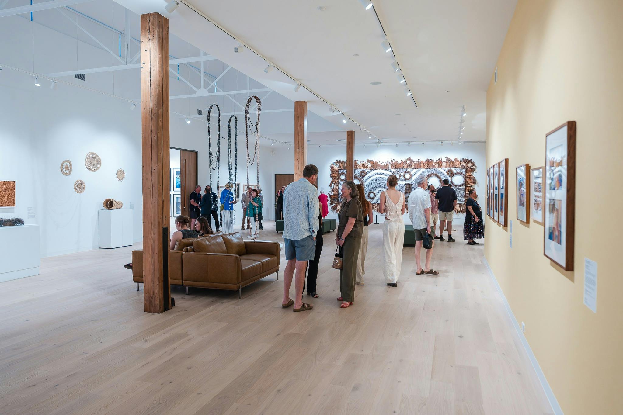 An internal photo of the gallery with people standing in the gallery
