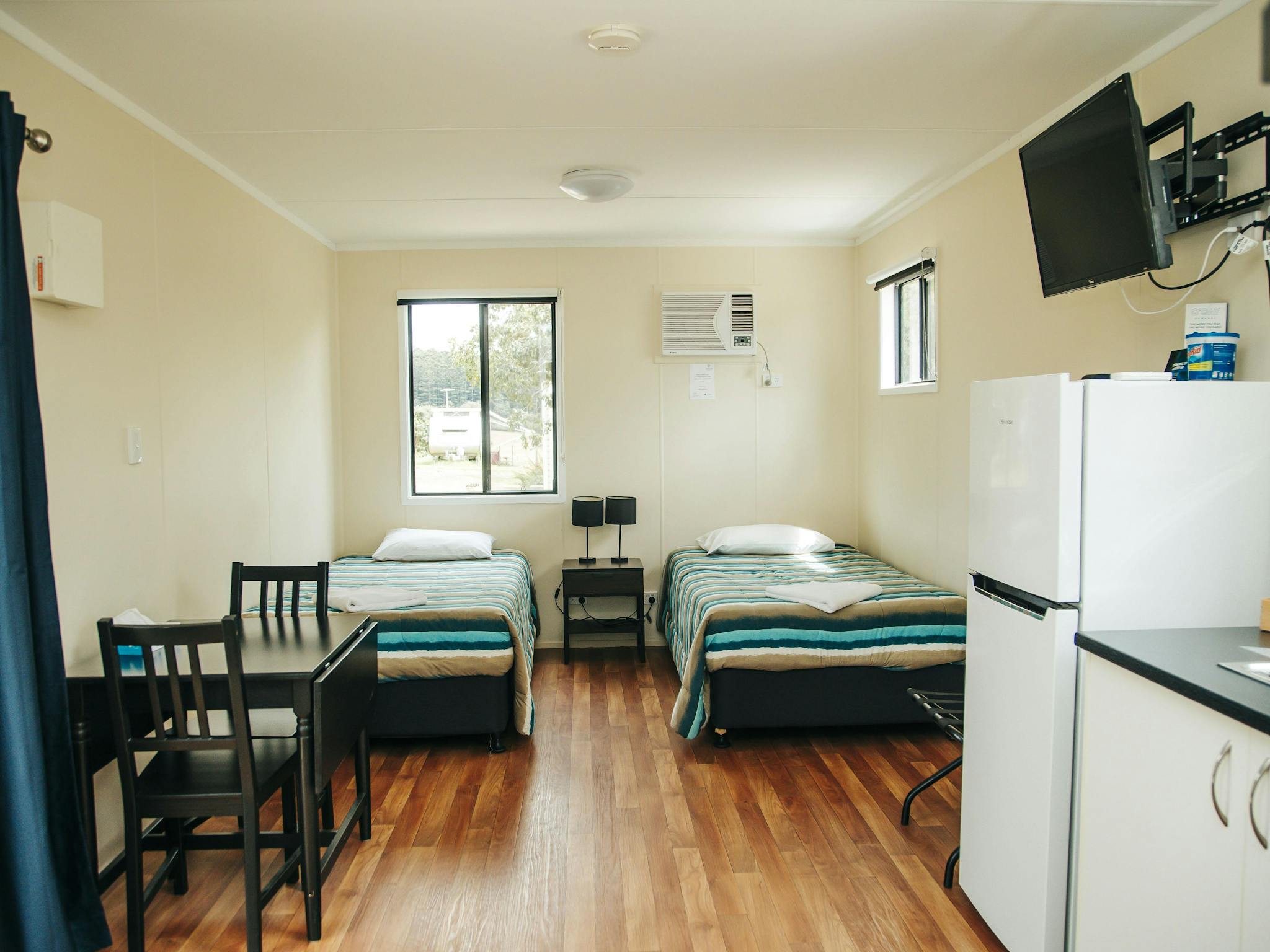 Deluxe Twin Cabin sleeping area with two king single beds and bedside table. Deluxe Twin Cabin sleeping area with two king single beds and bedside table.